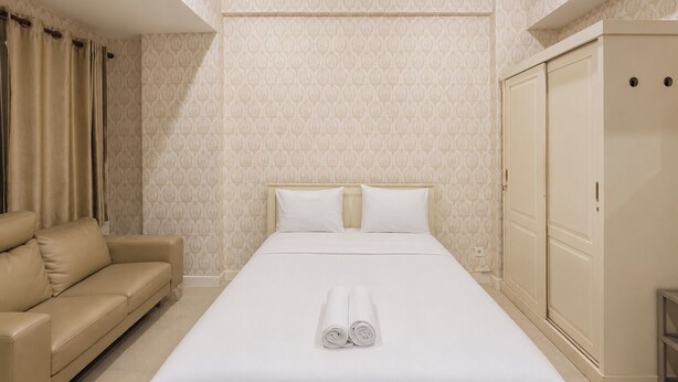 Ein Hotelzimmer mit einem Bett, einer Couch und einem Kleiderschrank.