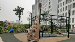 A playground with a climbing structure and a blue watering can. - Good Living In Spacious 2Br At Apartment M-Town Residence (Tangerang)