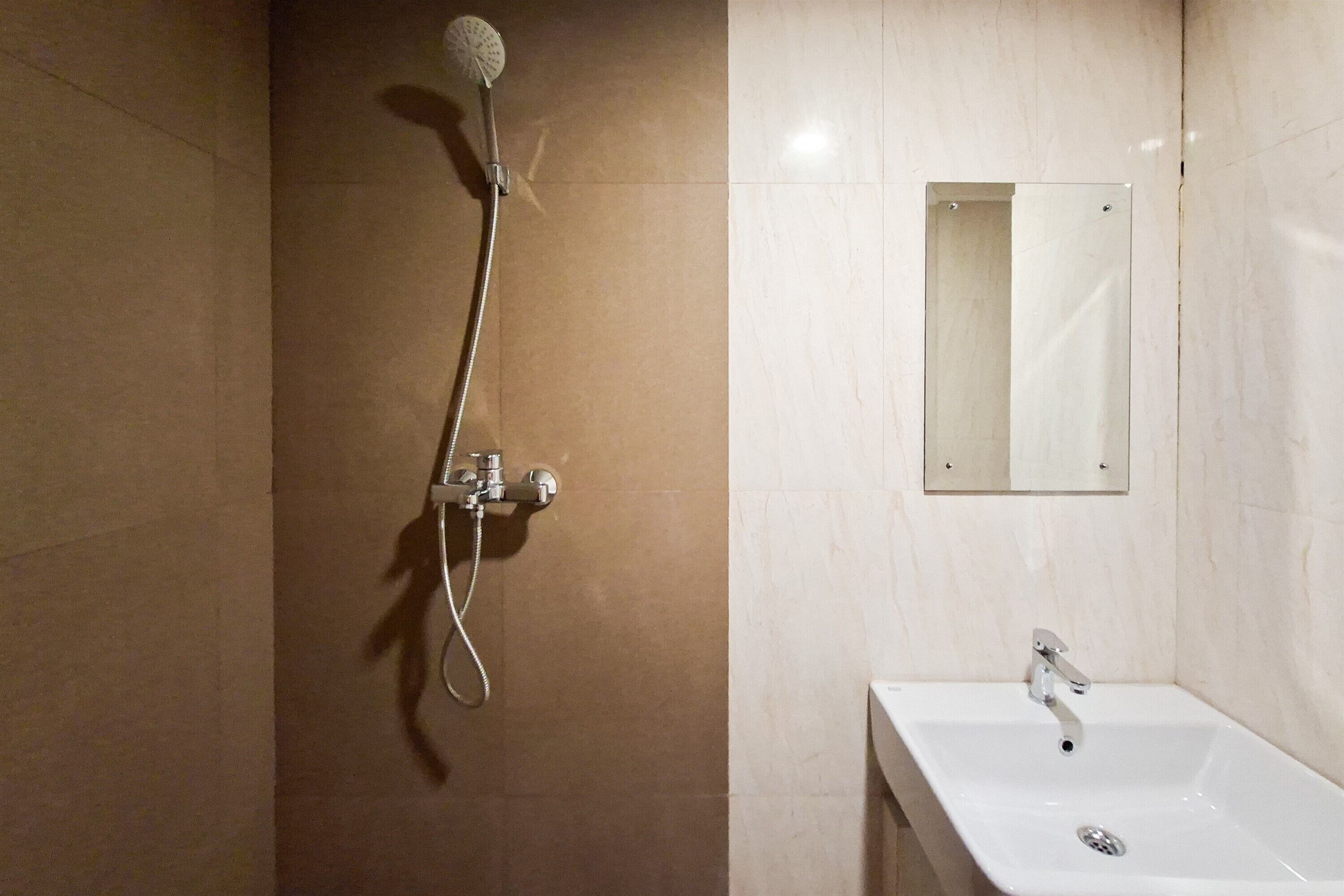 A bathroom with a shower, sink, and mirror.