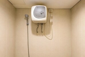 A shower with a control panel, a handheld showerhead, and a hose. - Good Deal Studio (No Kitchen) Apartment Skyland City Jatinangor (Sumedang)