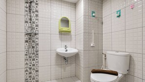 A bathroom with a toilet, sink, shower, and a mirror. - Warm Stay In Studio Room At Apartment De Prima (Medan)