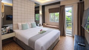 A hotel room with a large bed, a TV, a bedside table, a window with curtains, and a balcony. - Warm Combined 3Br At Maple Park Sunter Apartment (Jakarta)