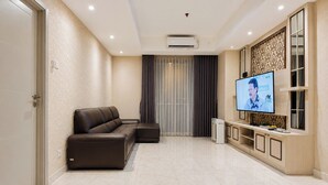 Een moderne woonkamer met een modulaire bank, een flatscreen televisie en een inbouwmeubel.