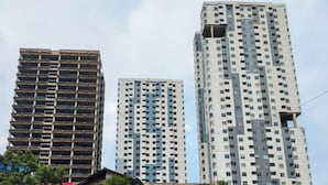 Three high-rise buildings with a modern architectural style, featuring multiple floors and a grid-like facade. - Serene 2Br Apartment Newton Residence Bandung (Bandung)