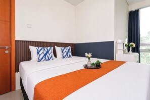 A hotel room with a bed, a nightstand, a window with curtains, and a door. - Stunning 2Br Apartment Woodland Park Residence (Jakarta)