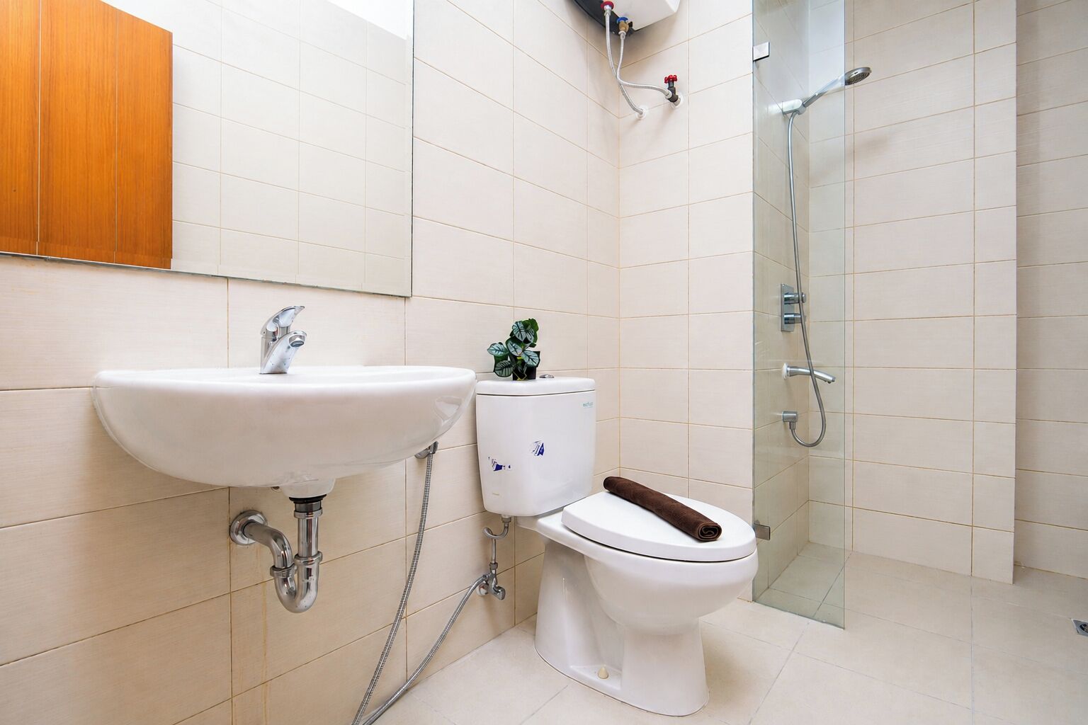 A bathroom with a sink, toilet, and shower.