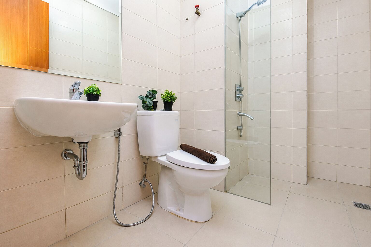 A bathroom with a sink, toilet, and shower.