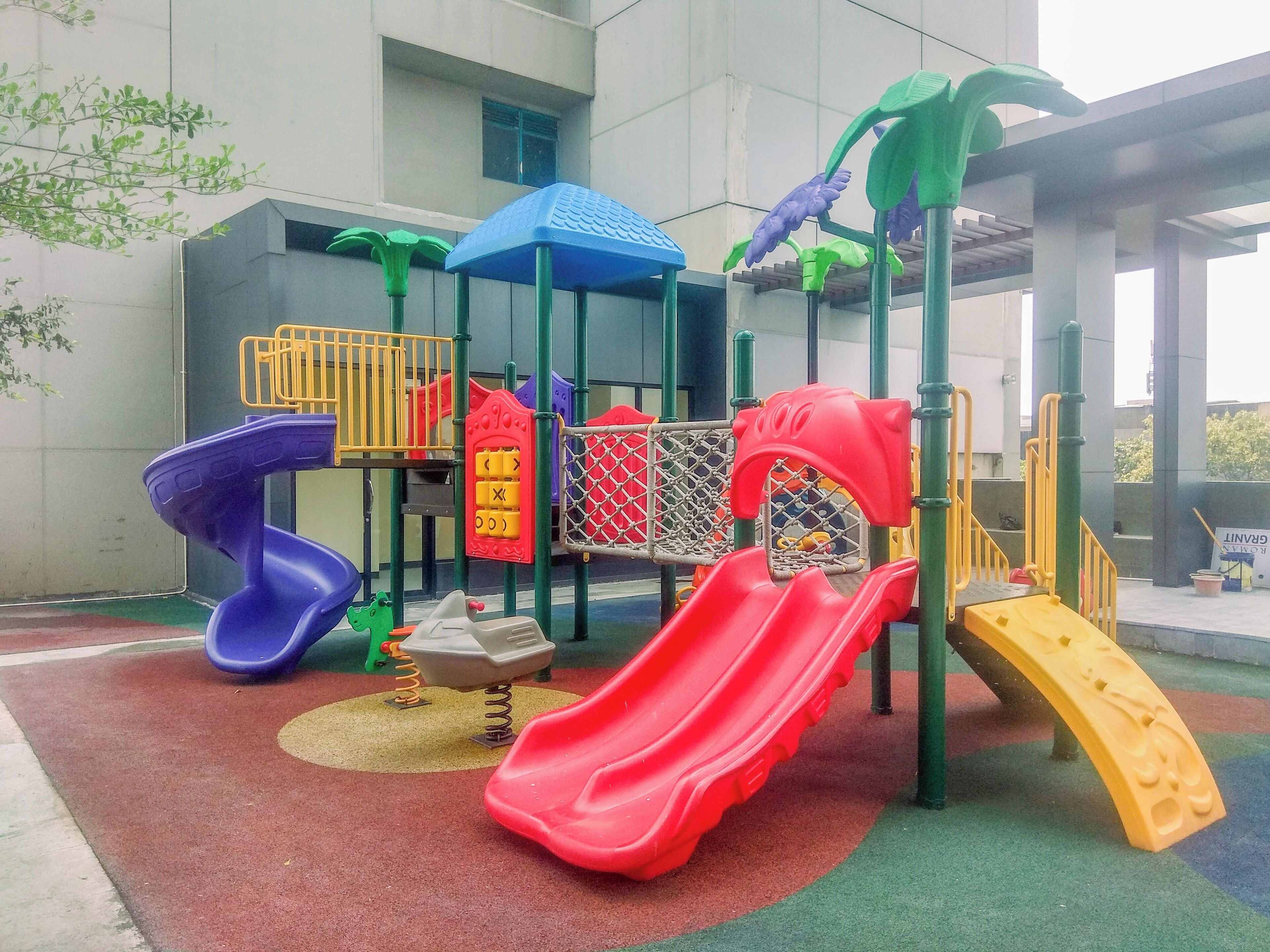 A playground with multiple slides and climbing structures.