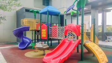 A playground with multiple slides and climbing structures.