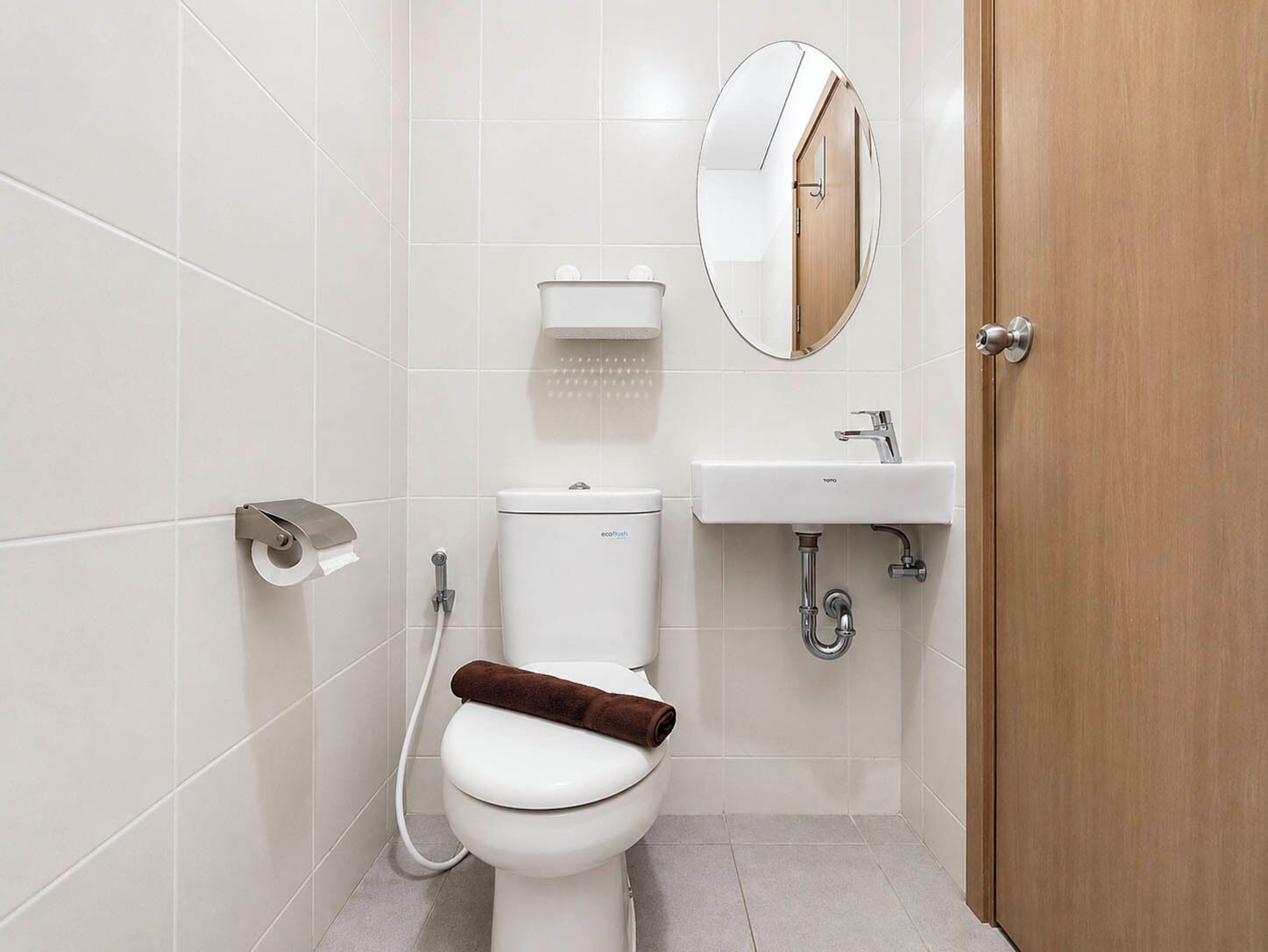 A modern bathroom with a toilet, bidet, and sink.