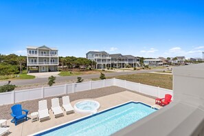 A residential area with a swimming pool, lounge chairs, and a hot tub. - Weekend Rescue: 10BR 10.5BA, Ocean Views, Pool, Hot Tub, Elevator, Dog Friendly, Sleeps 22 (Oak Island)