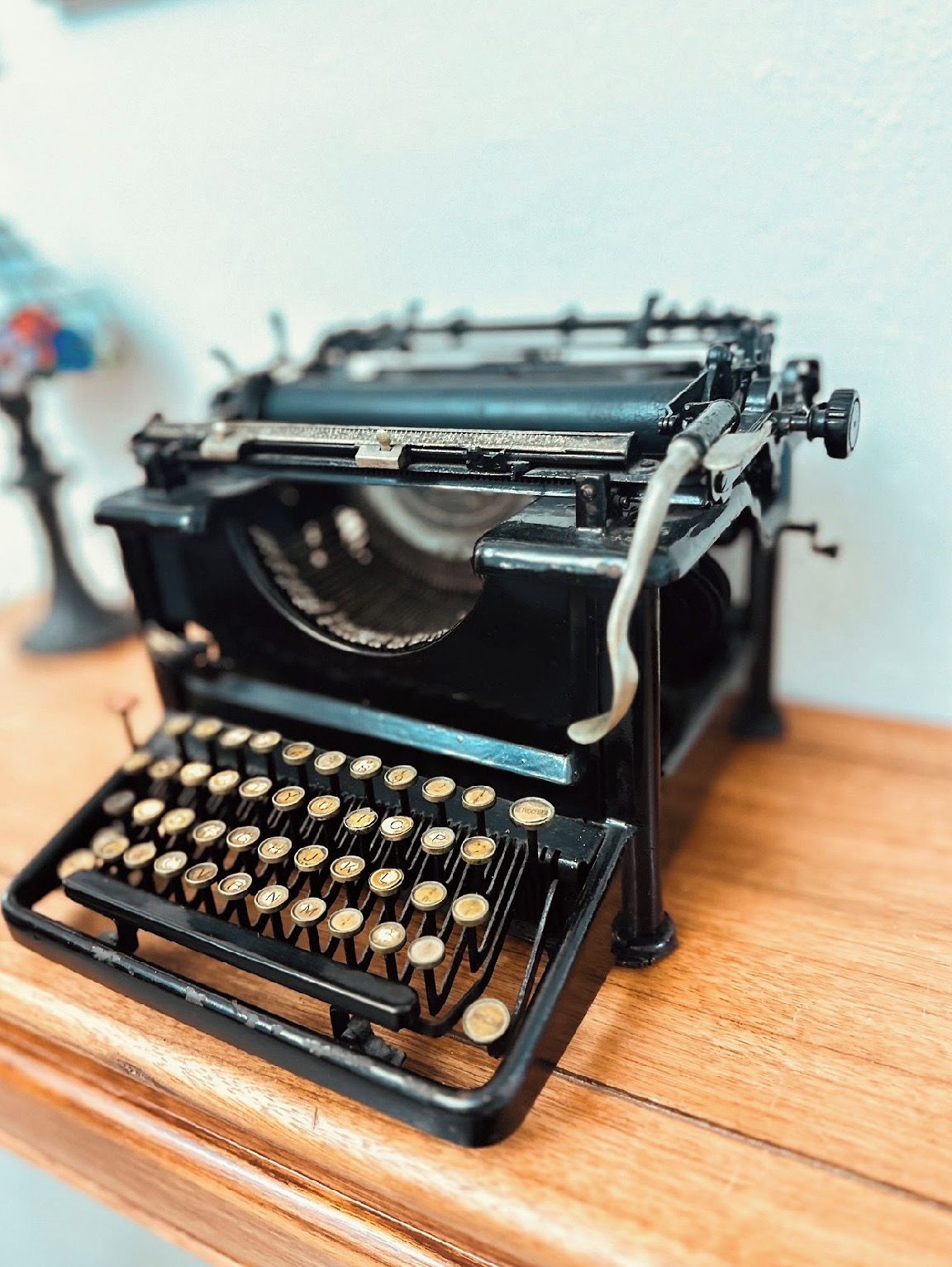 A vintage typewriter on a wooden surface.
