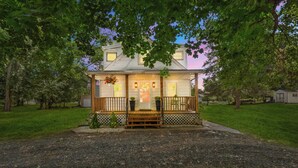 A house with a porch, a front door, and a small garden area.