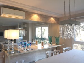 A modern kitchen with a central island, pendant lighting, and a view of the outdoors. - Floripa, the magic island - the life you always dreamed of,
now in your hands (Lagoa da Conceição Florianópolis)