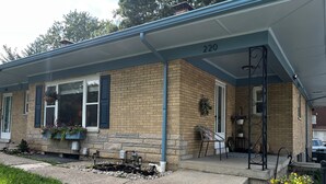 A residential building with a brick facade, a covered porch, and a number '220' on the wall. - Fiesta !-Fantastic 1-bedroom apartment with AC in charming Covington (Covington)