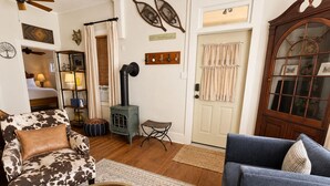 A cozy living room with a fireplace, a sofa, a chair, and a coffee table. - Walk to Downtown Long Term Rental with Wifi, Grill, Yard (Durango)