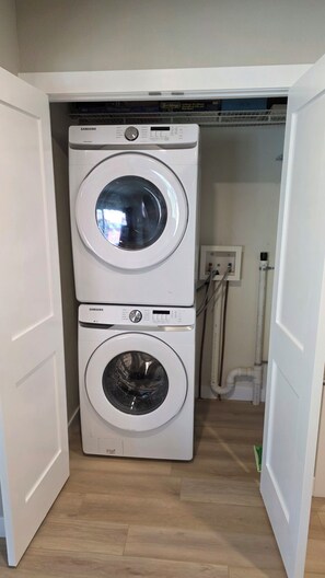 A laundry room with two stacked Samsung washing machines. - New Listing! True ski-in/out newly remodeled all-four seasons mountainside condo (Granby)