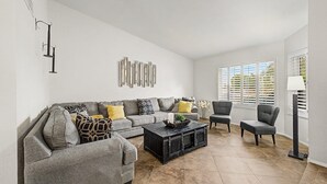 A living room with a grey sofa, a coffee table, and two armchairs. - Privat Pool w/ Diving Board, Arcade & BBQ, Prime N. Phoenix Location! (Phoenix)