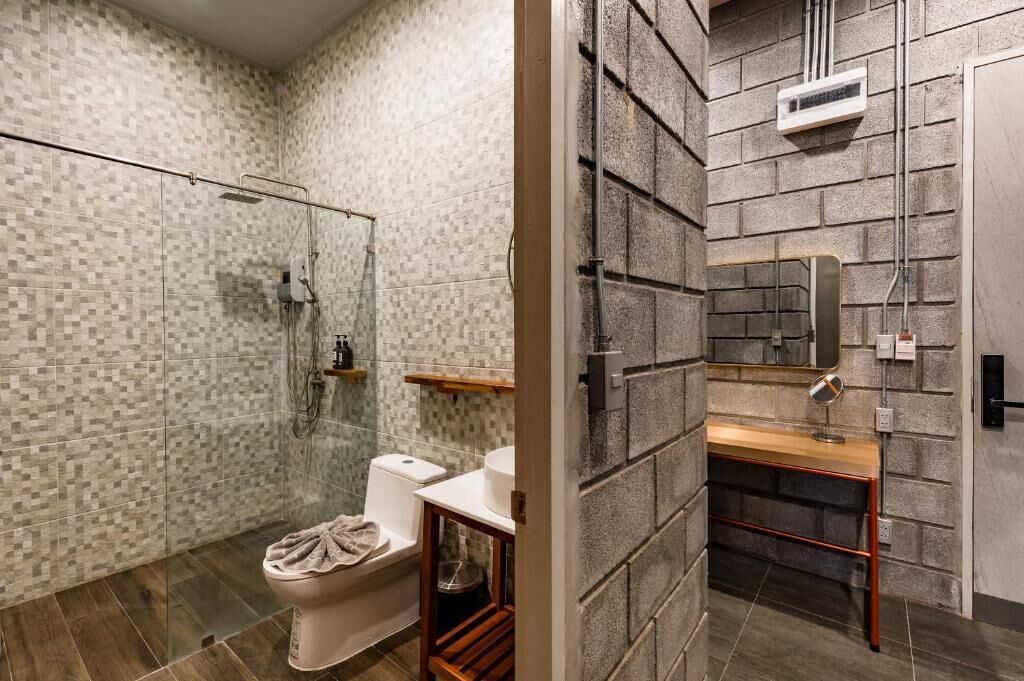 A bathroom with a shower, toilet, and sink.