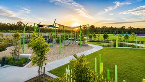 A playground with climbing structures and a sandbox area. - Haus Verde | 4BR Greenbank Hideout in Logan (Greenbank)