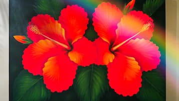 A painting of two hibiscus flowers with a dark background.