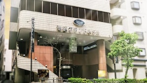 A hotel with a modern design, featuring a prominent sign, a staircase, and a large glass entrance. - Ikebukuro Grand Hotel (Tokyo)