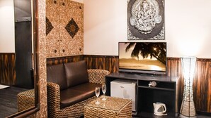 A room with a sofa, a television, a small refrigerator, and a decorative lamp. - Ikebukuro Grand Hotel (Tokyo)