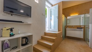 A modern kitchen with a built-in oven, a sink, and a window.
