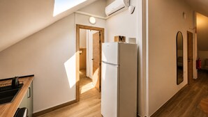 A kitchen with a skylight, a refrigerator, and a wooden countertop. - Madrid Pad With 2 Baths (Madrid)