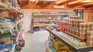 A store with shelves stocked with various items, including cleaning supplies, kitchenware, and food products. - Peacefully located beach house for families (Ellemeet)