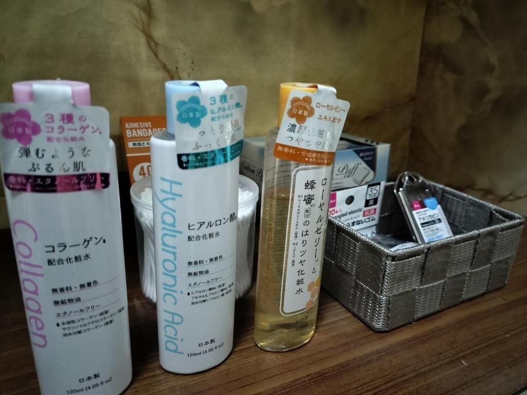 A collection of skincare products on a wooden surface.