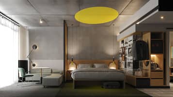 A modern bedroom with a bed, bedside tables, a wardrobe, and a seating area with a sofa and armchair.
