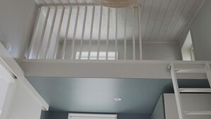 A room with a window, a ceiling fan, and a white railing. - 4 Star Holiday Home in Falkenberg (Falkenberg)