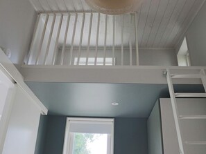 A room with a window, a ceiling fan, and a white railing. - 4 Star Holiday Home in Falkenberg (Falkenberg)