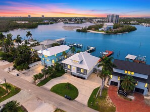 A coastal residential area with houses, a marina, and a view of the water. - Private Pool + Dock + Bay Views | Walk to Beach + Times Square | Sunset Slip (Fort Myers Beach)