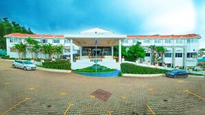 A hotel with a central building, a parking area, and surrounding greenery. - Grand Palace Yercaud (Yercaud)