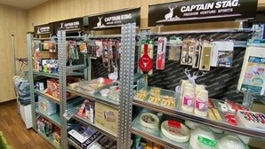 A store with shelves stocked with various items, including snacks and beverages.