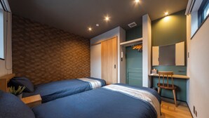 A bedroom with two beds, a wardrobe, a desk, and a chair. - Activity Base Hida-takayama (Takayama)
