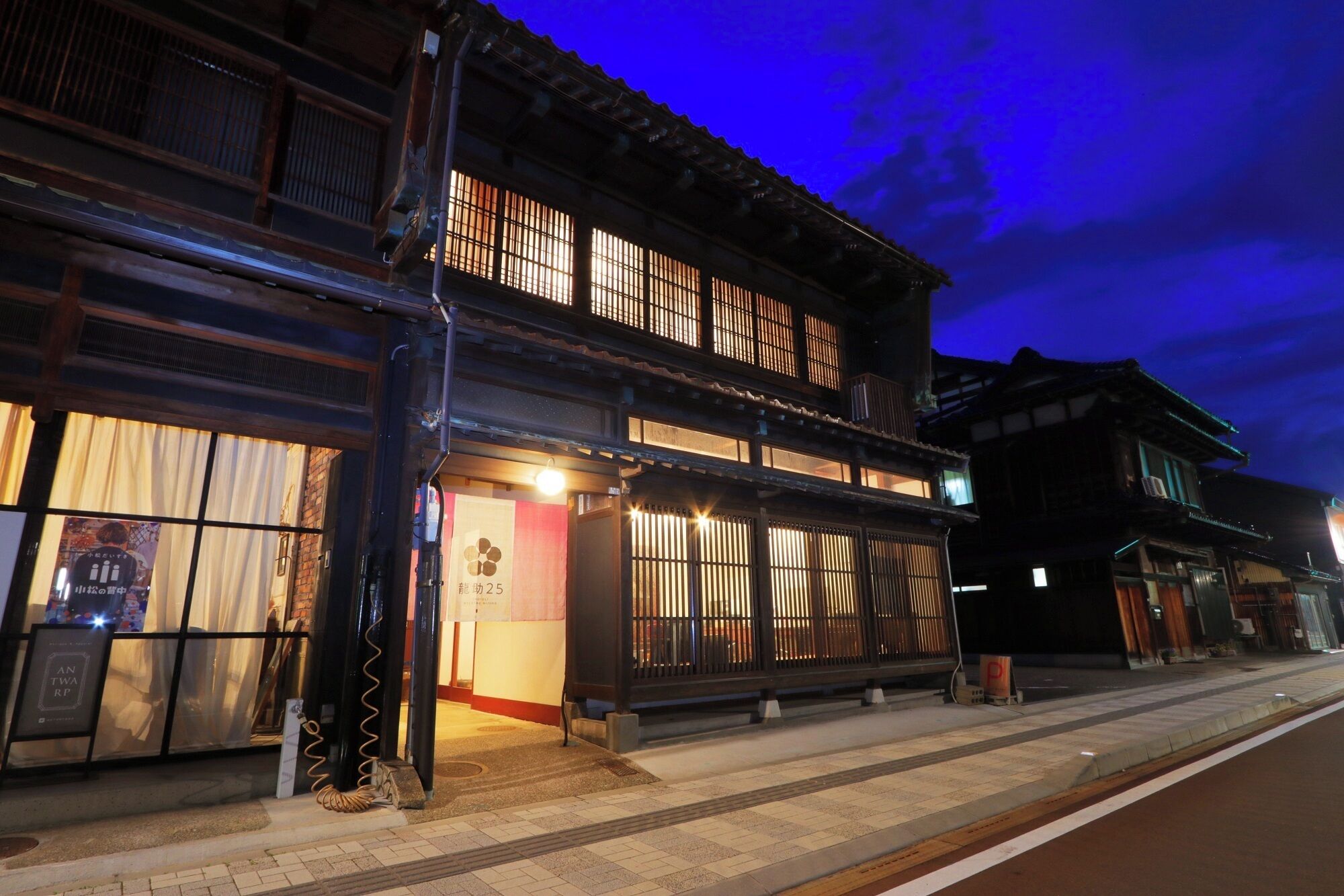 A traditional Japanese building with multiple windows and a tiled entrance.