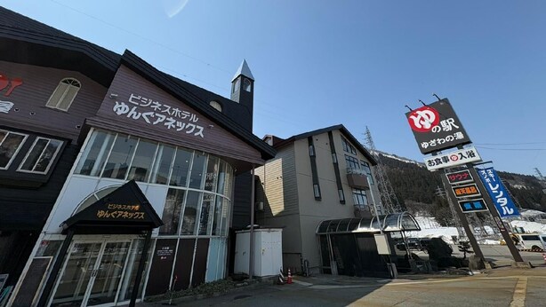 A building with a sign that reads 'ビジネスホテル ゆんばアネックス' and another sign with 'お賃貸' and 'ワンデー'. - Yungu Annex (Yuzawa)