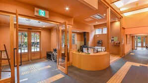 A hotel lobby with a reception desk, wheelchair-accessible entrance, and a visible exit sign. - Hanazono Onsen Kaho no Sato (Katsuragi)