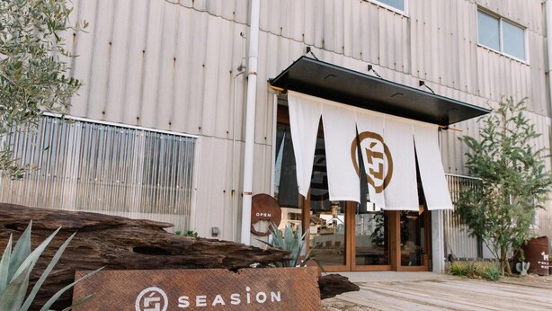 A building with a modern design, featuring a large sign with the word 'SEASON' and a logo. - Seasion (Shodoshima)