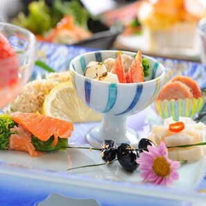 A variety of food items on a table, including salmon, cheese, and other delicacies. - Iizaka Onsen Azumaso (Fukushima)