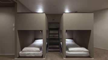 A room with two bunk beds, a staircase, and a carpeted floor.
