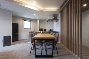 A modern kitchen with a wooden table and chairs, a black refrigerator, and a window. - ENT TERRACE GAKUGEIDAIGAKU PREMIUM (Meguroku)