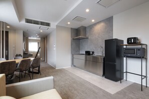 A modern kitchen with a dining area, stainless steel appliances, and a built-in microwave. - ENT TERRACE GAKUGEIDAIGAKU PREMIUM (Meguroku)