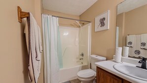 A bathroom with a shower, toilet, sink, and towel rack. - 3BR Atlanta Airport Home | Pet Friendly + Parking (Union City)