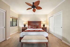 A bedroom with a bed, a bench, a ceiling fan, and two bedside lamps. - Golf Course Condo Near Beaches & Sunset Views -Kapalua Golf Villas 17P78 (Lahaina)