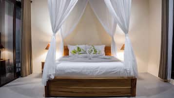 A four-poster canopy bed with white bedding and a wooden base, flanked by two bedside tables with lamps.