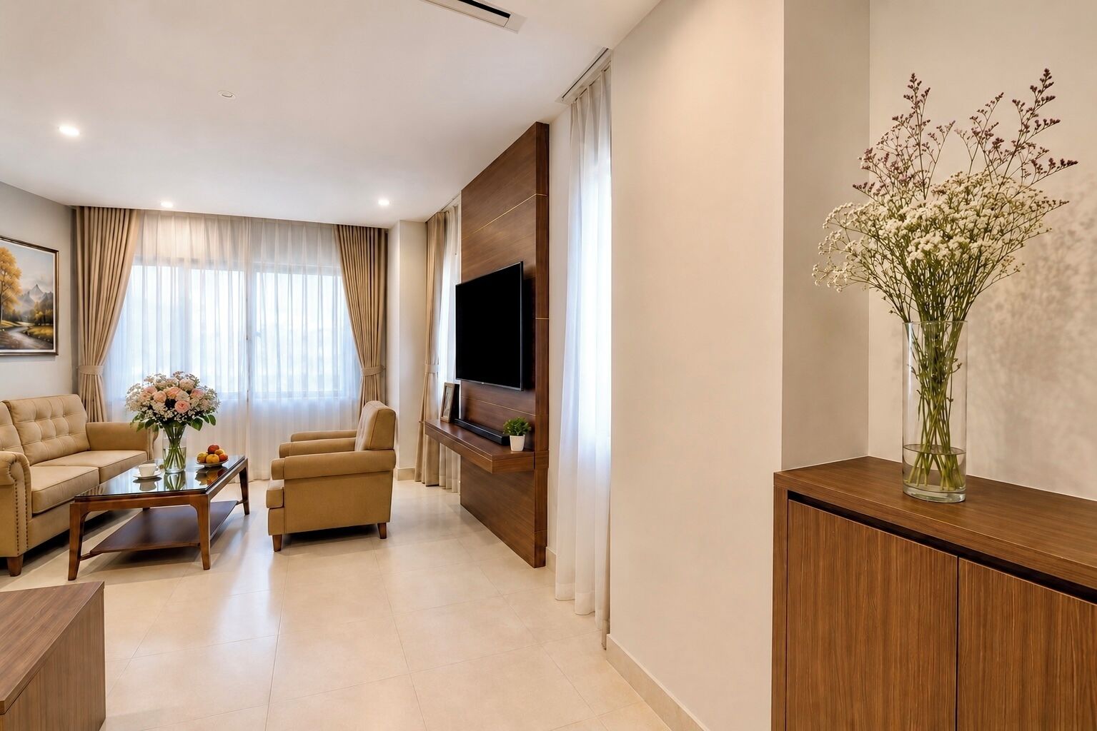 A modern living room with a sofa, armchair, coffee table, and a flat-screen TV mounted on a wooden wall.